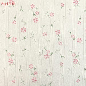 May include: Off-white fabric featuring a vertical ribbed texture with a repeating pattern of small pink flowers and green stems. The text Style 51 is printed in the upper left corner. The material has a subtle, perforated dot pattern.