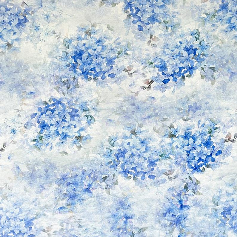 May include: A fabric pattern featuring clusters of blue hydrangea flowers on a light, off-white background. The design displays various shades of blue, ranging from pale sky blue to deep cobalt, with soft watercolour-style petals and green leaves.