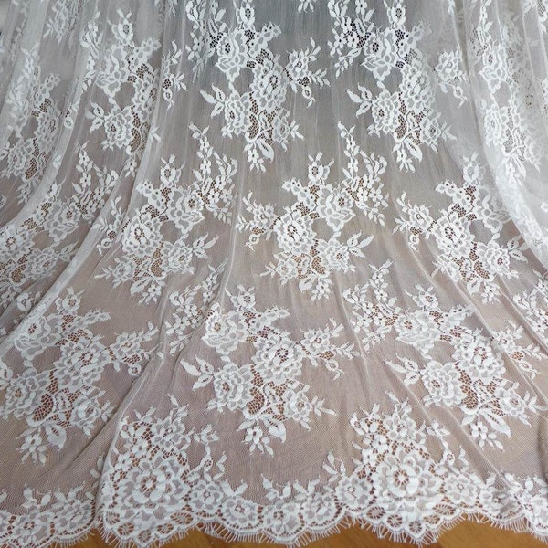 Lindo tecido branco com renda floral macia, 152 cm de largura, ideal para confecção de vestidos de noiva.