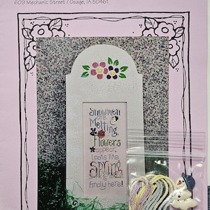 May include: Cross stitch kit titled "Looks Like Spring" with a colorful floral design and a snowman melting. The kit includes floss and a small snowman charm.