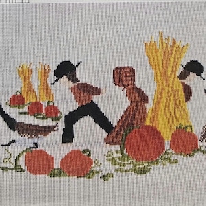 May include: Cross-stitch design depicting an autumn harvest scene. Two figures in hats and dark clothing are near pumpkins, geese, and a haystack. The color palette includes orange, brown, black, and yellow, creating a rustic feel.
