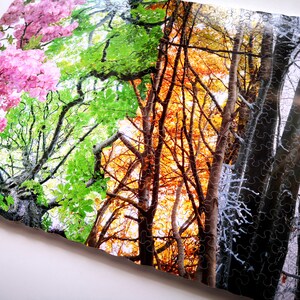 May include: A jigsaw puzzle depicting four seasons of a forest. The left side shows a tree in full bloom with pink flowers. The next section shows the same tree with green leaves. The third section shows the tree with orange and yellow leaves. The final section shows the tree with bare branches covered in snow.