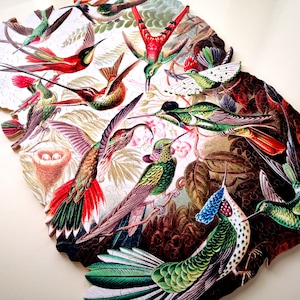 May include: A colorful wooden jigsaw puzzle featuring a variety of hummingbirds with intricate details. The birds are depicted in a vibrant array of colors, including red, green, blue, and yellow, against a backdrop of lush foliage.