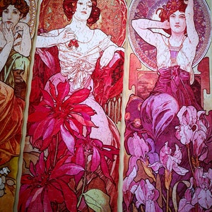 May include: Three panels of a vintage art nouveau style jigsaw puzzle featuring three women in elaborate dresses and floral designs. The women are depicted with long flowing hair and delicate features. The floral designs are intricate and colorful, with shades of pink, red, and purple.