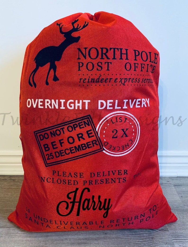 May include: Red Christmas gift sack with black text and a reindeer silhouette. Text includes "North Pole Post Office," "Overnight Delivery," "Do Not Open Before 25 December," and the name "Harry." A festive holiday gift bag.