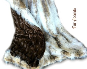 May include: A brown and white faux fur throw blanket with a brown quilted backing. The blanket is folded and draped over a white surface. The text "Fur Accents" is visible in the image.