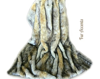 May include: A faux fur throw blanket in shades of brown, gray, and white. The blanket is folded and draped over a white background. The text "Fur Accents" is visible in the image.