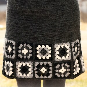 May include: A gray crochet skirt with a black, white, and gray granny square trim.