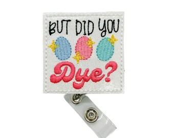 May include: White glitter badge reel with a white square patch that says "But did you dye?" with three colorful Easter eggs and gold glitter stars.