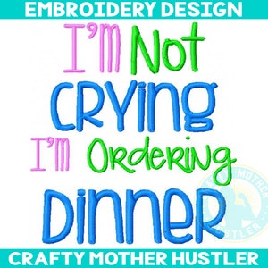May include: Embroidery design featuring the text "I'm not crying I'm ordering dinner" in pink, green, and blue lettering. The design is for embroidery and is available for purchase.