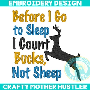 May include: Embroidered design with the text "Before I Go to Sleep I Count Bucks, Not Sheep" in yellow, blue, and black lettering. A black silhouette of a deer is jumping in the center of the design. The text "CRAFTY MOTHER HUSTLER" is at the bottom of the design.