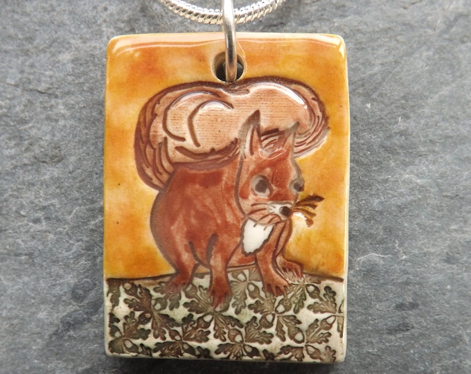 Ceramic Red Squirrel pendant with sunset yellow background, wildlife lover gift