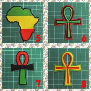 May include: Four iron-on patches, two featuring the Ankh symbol in red, green, and yellow, and two featuring a green, yellow, and red outline of the African continent.