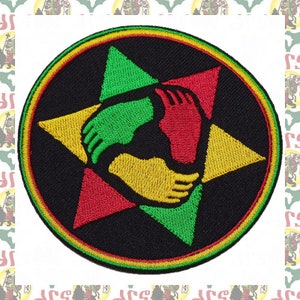 May include: A black and yellow embroidered patch with three hands clasped together in a circle. The hands are red, green, and yellow. The patch is surrounded by a red, yellow, and green border.