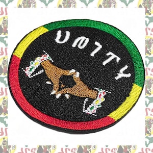 May include: A round black patch with a red, yellow, and green border. The patch features two hands clasped together in a handshake and the word "UNITY" written in white.