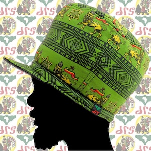 May include: A green hat with a patterned design featuring lions, stars, and geometric shapes. The hat has a flat brim and a crown that is taller than the brim.