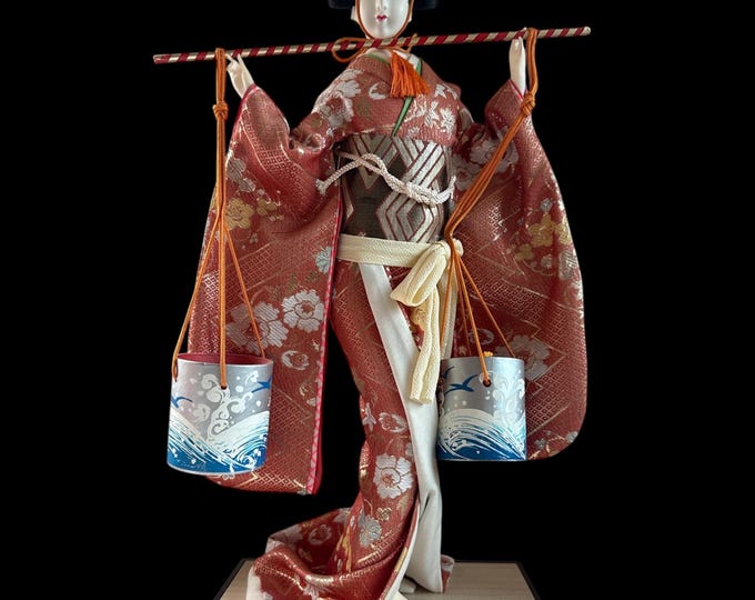 Japanese Geisha in Kimono Carrying Water Buckets Doll. This gorgeous and adorable geisha doll. Dressed in an opulent traditional costume.