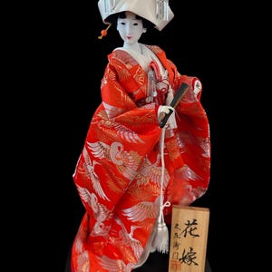 Bride Geisha Girl Doll Gorgeous and adorable geisha doll. is dressed in an opulent traditional costume.