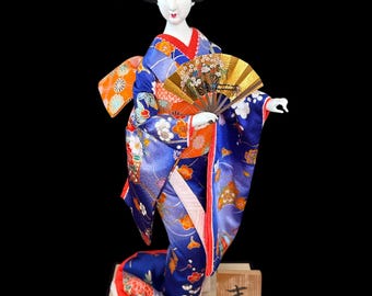 Good fortune and prosperity Geisha Girl Doll This gorgeous and adorable geisha doll. Dressed in an opulent traditional costume.