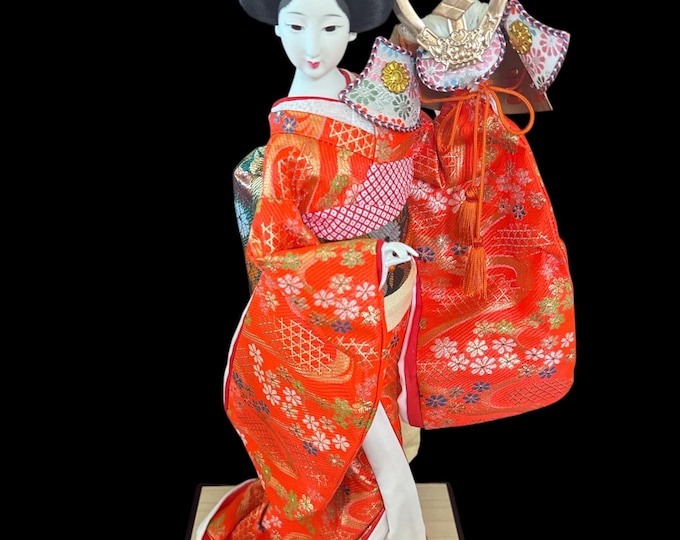 Geisha Girl with Warrior Helmet Doll Gorgeous and adorable geisha doll. is dressed in an opulent traditional costume.