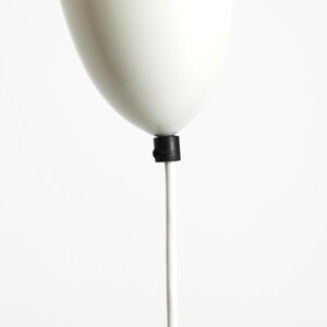 May include: White pendant light fixture with a white cord and a black connector.