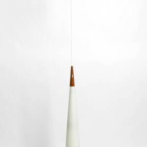 May include: A white teardrop-shaped glass pendant light with a wooden top hangs from a white ceiling.