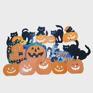 May include: A collection of Halloween-themed paper cutouts featuring orange jack-o'-lanterns with various facial expressions, black cat silhouettes, and a skeleton figure wearing a top hat. One cutout displays the text Happy Halloween in blue.