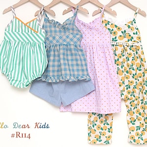 May include: Four children's outfits hanging on wooden hangers. The outfits include a green and white striped romper, a blue gingham top with blue shorts, a pink polka dot dress, and a yellow floral print outfit. The text "Hello Dear Kids #RII4" is at the bottom.