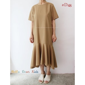May include: A brown, knee-length dress with a ruffled hem. The dress has short sleeves and a round neckline. The dress is #D48.