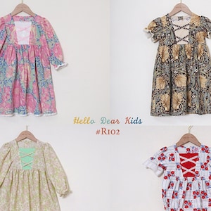May include: Four different children's dresses with floral patterns. The dresses have different necklines, sleeves, and lengths. The dresses are all made of cotton and have a vintage look. #RIO2 Hello Dear Kids