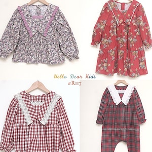 May include: Four pieces of children's clothing hanging on a rack. The items include a floral print blouse, a red floral dress, a red and white checkered romper, and a red plaid jumpsuit. The text "Hello Dear Kids #R117" is visible.