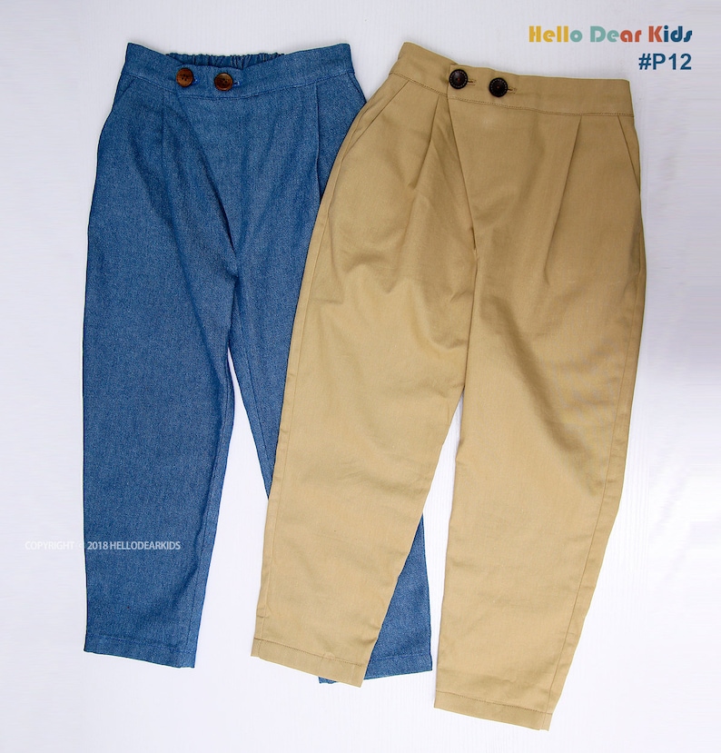 May include: Two pairs of pants, one blue denim and one khaki, with a button closure and a single pleat on each leg.  The pants are laid flat on a white surface.  The text "Hello Dear Kids #P12" is visible in the top right corner of the image.