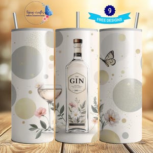 May include: Three stainless steel tumblers with a white background and a pattern of grey circles. The centre tumbler features a bottle of gin with a floral design and the word "GIN" in black text. The tumbler on the left has a martini glass with a floral design. The tumbler on the right has a butterfly design.