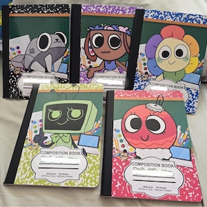 May include: A collection of five composition notebooks with unique cartoon character designs. Each notebook features a different character on the cover, including a frog, a girl with a flower crown, a flower, a TV, and an ornament. The notebooks are 9.75 x 7.5 inches.
