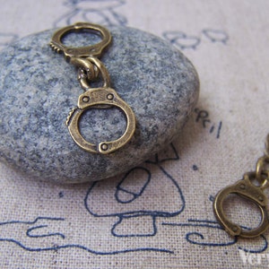 10 pcs of Antique Bronze Handcuff Charms 11x30mm A1602