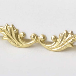 May include: A gold-colored metal decorative trim with a swirling, leaf-like design. The trim is perfect for adding a touch of elegance to furniture, crafts, or home decor.