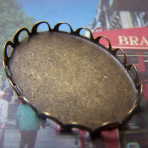 May include: A brass oval-shaped tray with a scalloped edge. The tray is blank and ready for a craft project.