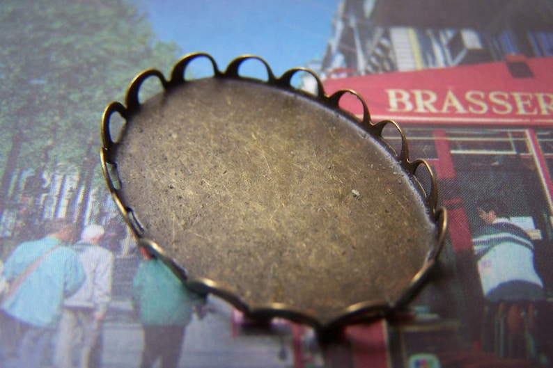 May include: A brass oval-shaped tray with a scalloped edge. The tray is blank and ready for a craft project.