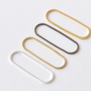May include: Four oval-shaped metal rings in different finishes: gold, silver, brass, and antique brass.