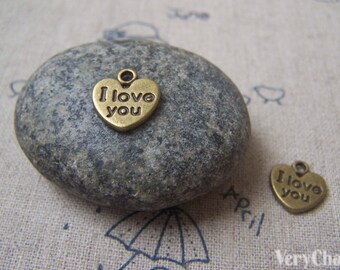 May include: Two antique gold-tone metal heart-shaped charms with the words "I love you" engraved on them.