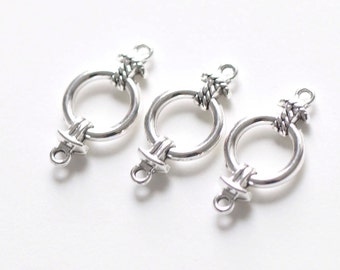 May include: Three silver-toned metal ring clasps with a rope-like design. Each clasp has a small loop on the bottom.