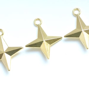 May include: Three gold-coloured star charms with a loop at the top for hanging. The charms have a four-pointed star design with angled facets. The stars are displayed on a white background.
