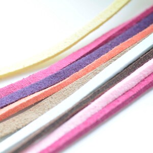 May include: Assortment of colorful suede leather cords in various shades of pink, orange, purple, brown, white, and yellow.