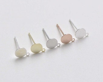 May include: Five silver earring posts with round metal discs attached. The discs are in different colors: silver, gold, rose gold, and two shades of silver.