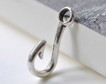 May include: Silver-toned metal hook charm with a rounded top loop. The hook is curved and has a sharp point.