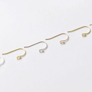 May include: Five earring hooks in different metal finishes: silver, gold, rose gold, and two shades of gold. The hooks are all the same size and shape, with a small loop at the top and a curved wire that ends in a point.