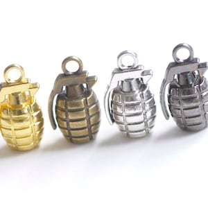 May include: Four miniature grenade charms in gold, bronze, silver, and black metal.