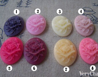 May include: Eight oval-shaped resin cabochons with a raised floral design. The cabochons are in various shades of pink, purple, and cream. The cabochons are numbered 1 through 8.