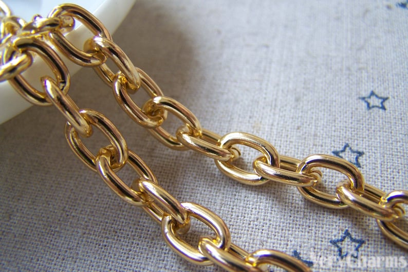 May include: Gold chain with oval links. The chain is thick and has a shiny finish.