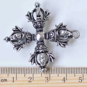 May include: Silver-toned metal pendant in the shape of a four-pointed star with intricate details. The pendant measures approximately 3 cm in diameter.